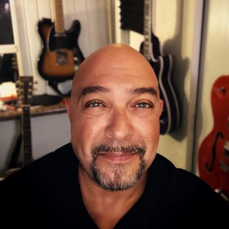 Manny Lee with a few of his guitars.